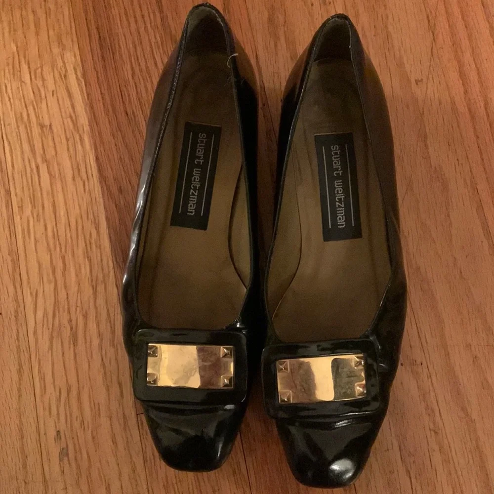 Stuart Weitzman black patent leather loafers with gold plaques and low heel 6